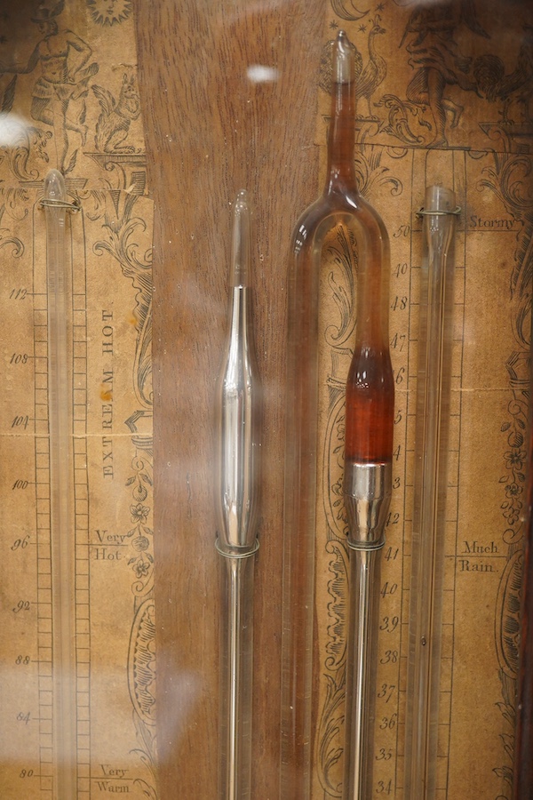 A George III mahogany multi-tube barometer together with integral thermometer by Sala, London, in a mahogany glazed case with arched pediment and three brass finials, paper scales with maker’s mark, height 61cm. Conditio